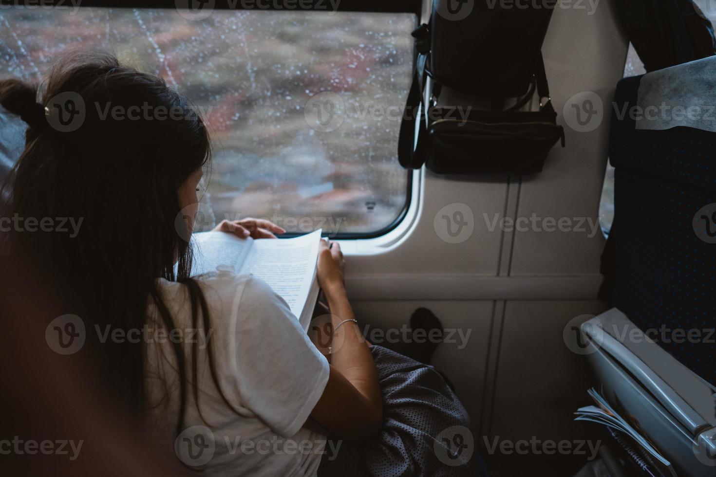 Young happy woman sitting in city bus photo