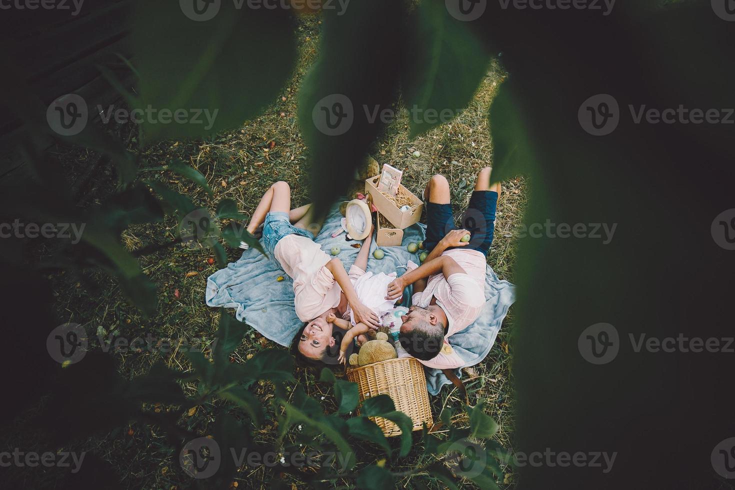 Happy family on lawn in the park photo