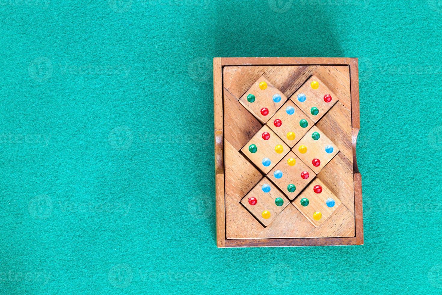 top view of wooden box with puzzle on green table photo