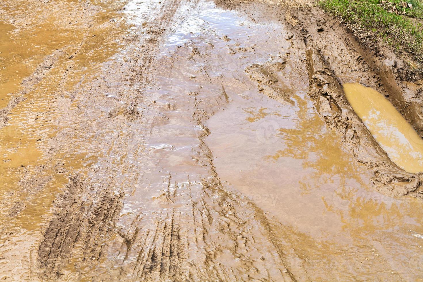 mud and puddle at dirt road photo