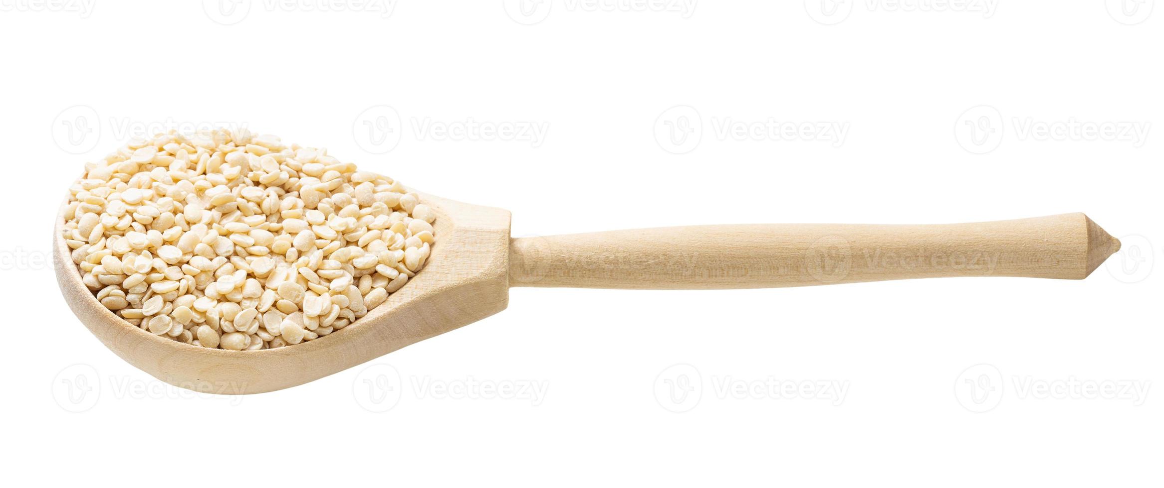 urad dal split black gram beans in wooden spoon photo