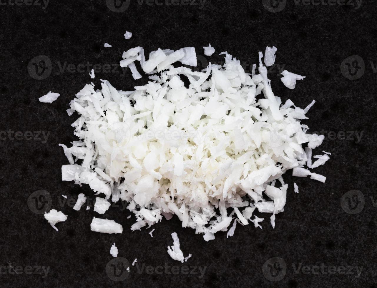view of pile of coconut flakes close up on black photo
