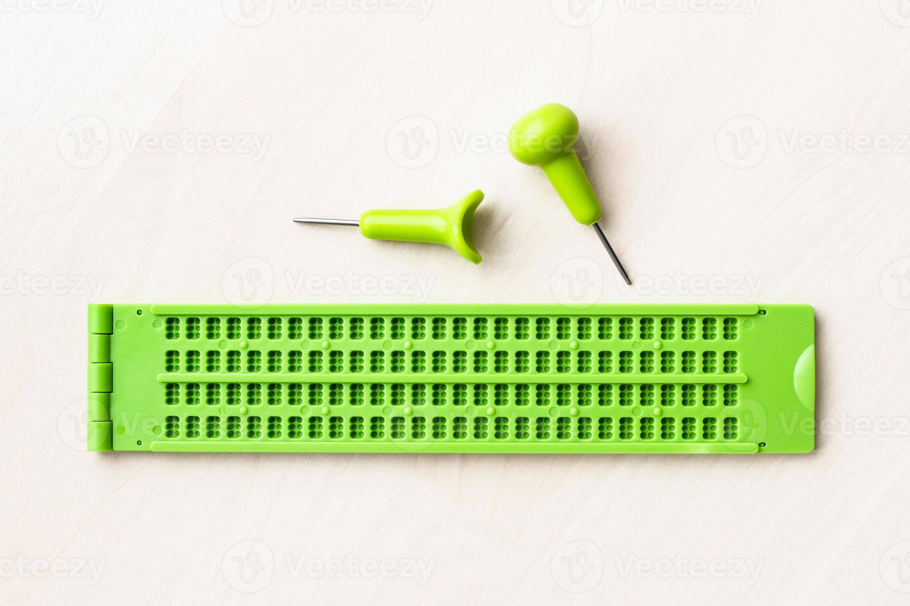 top view of braille writing slate and stylus 11450428 Stock Photo at