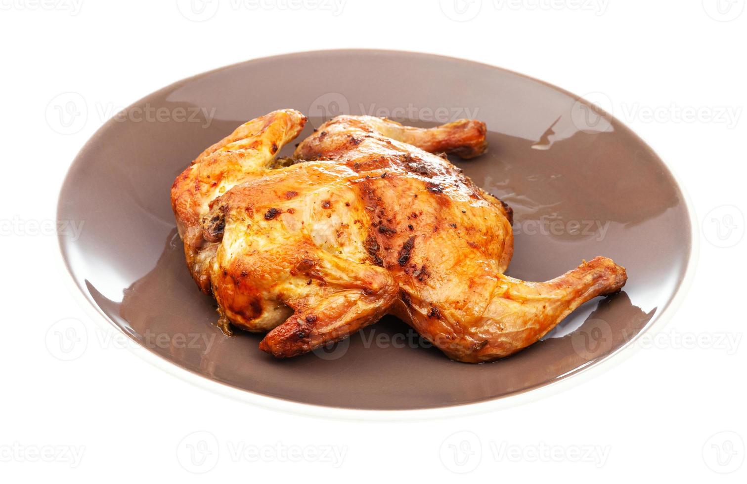 roasted whole flattened chicken on brown plate 11450444 Stock Photo at