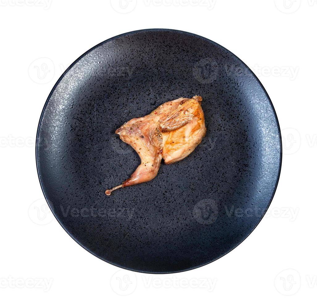 top view of half of fried quail on plate isolated photo