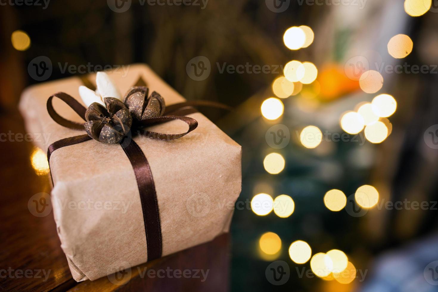 Beautiful themed gifts lie on vintage table. Background with garland bokeh photo