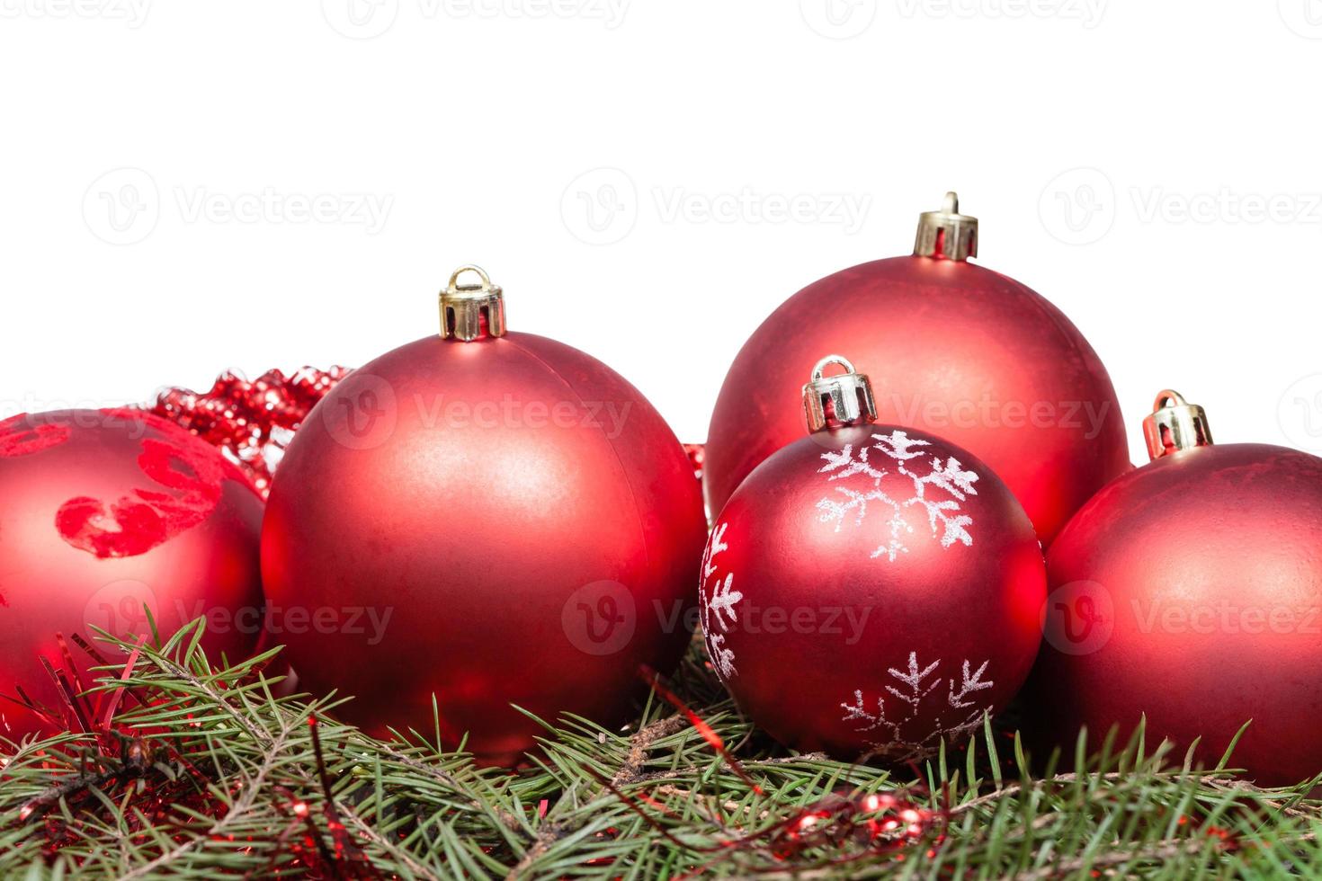 red Christmas balls on green spruce branch photo
