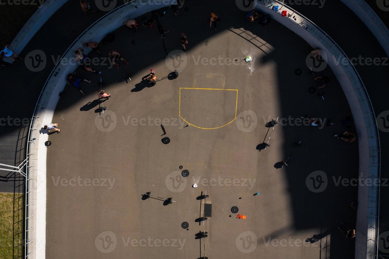 Aerial footage of a sports ground, people doing weightlifting photo