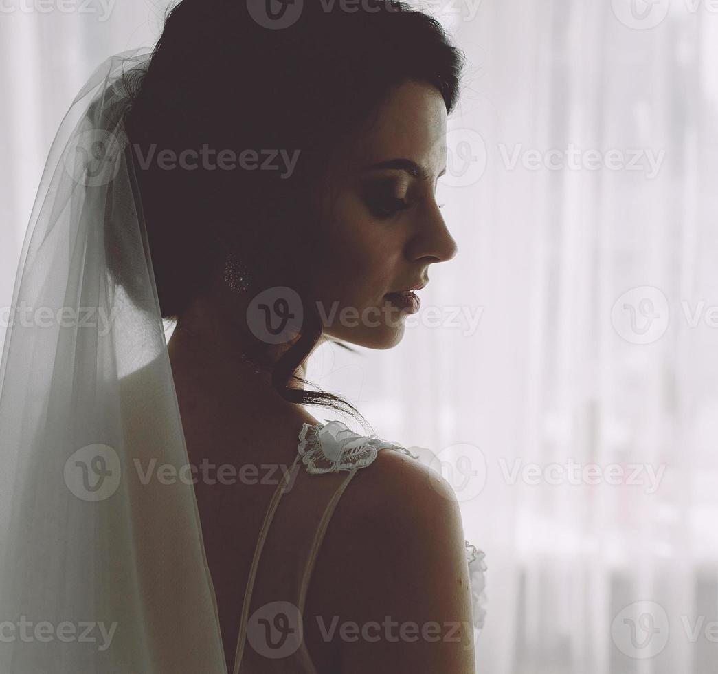 Bride posing in a large window photo