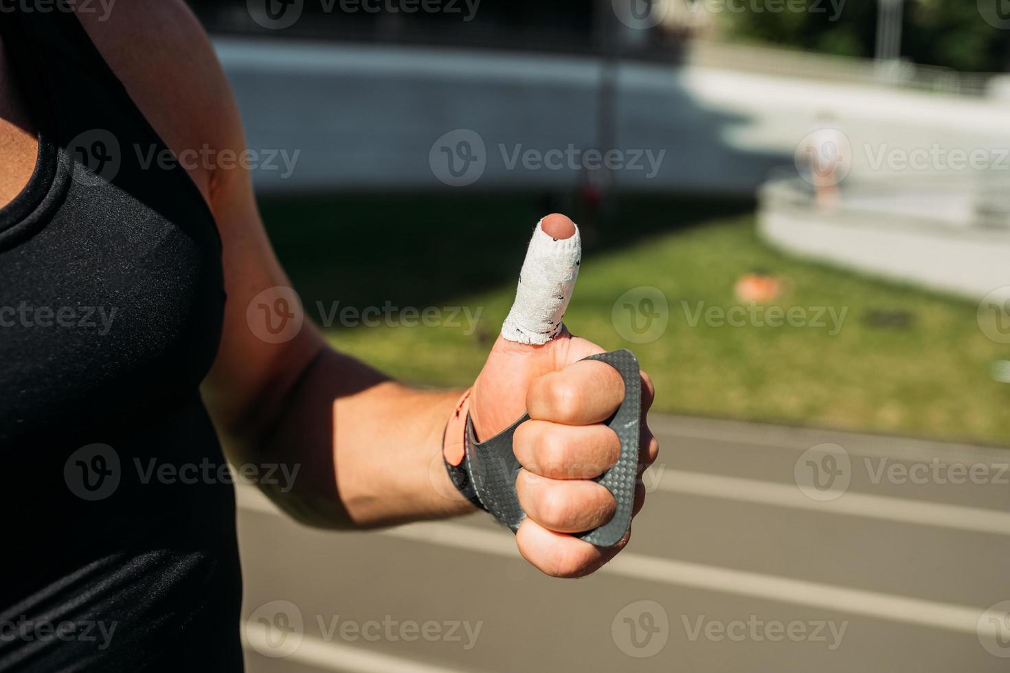 cropped view of sexy bodybuilder showing thumbs up photo