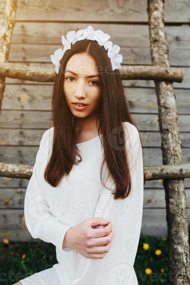 Lovely girl near a wooden house photo