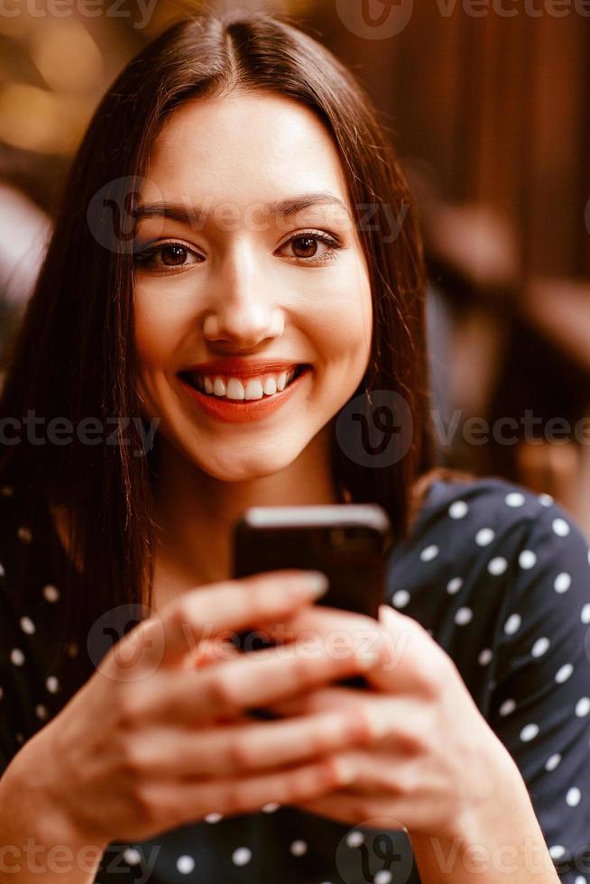 Beautiful girl talking on the phone and smiling.  Instagram toning effect photo