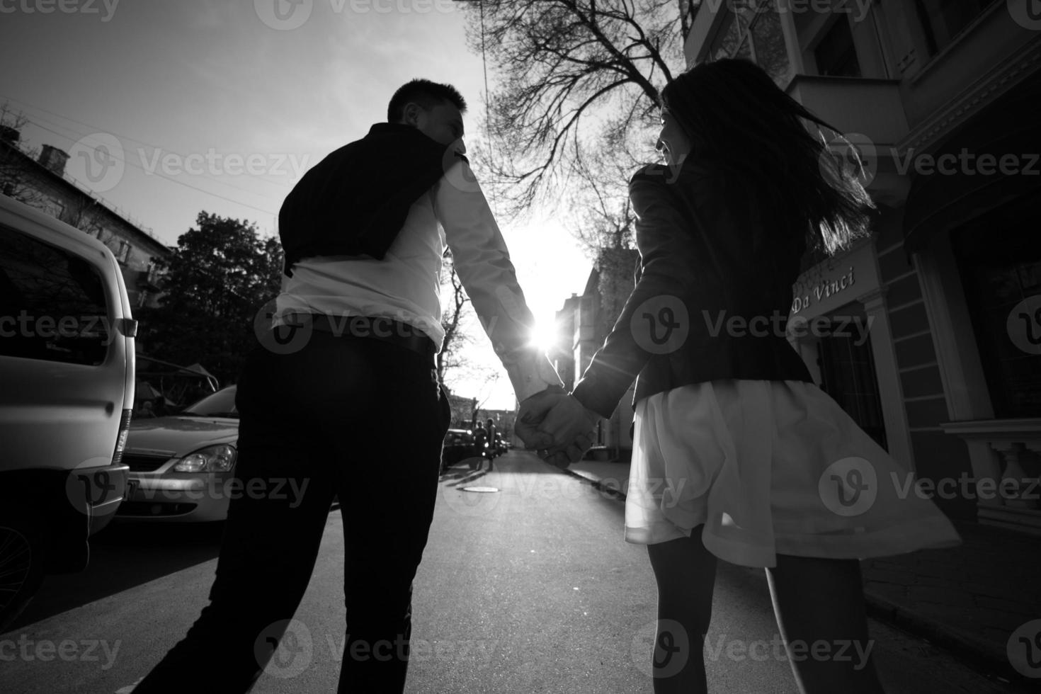 Couple holding hands and walking photo