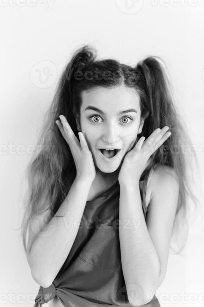 Surprised young girl with pigtails photo