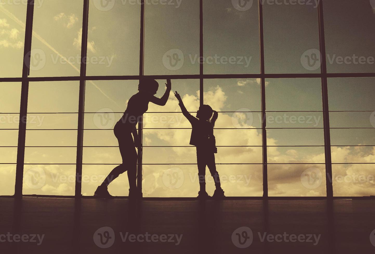 Silhouette of mother and daughter in the gym photo