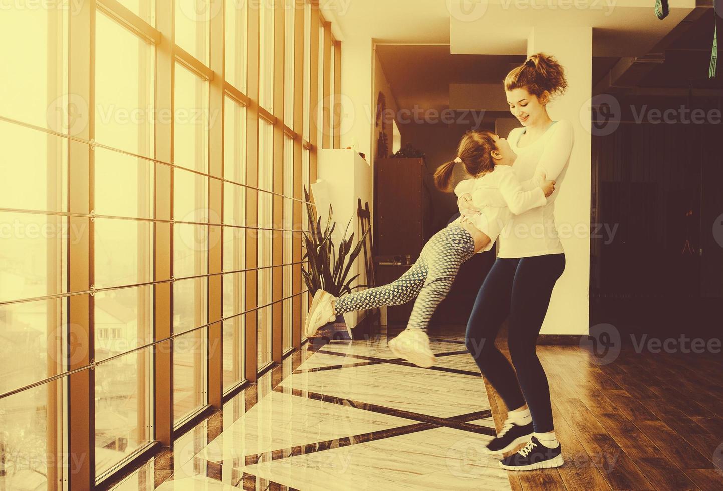 Mother and daughter have fun in the gym photo