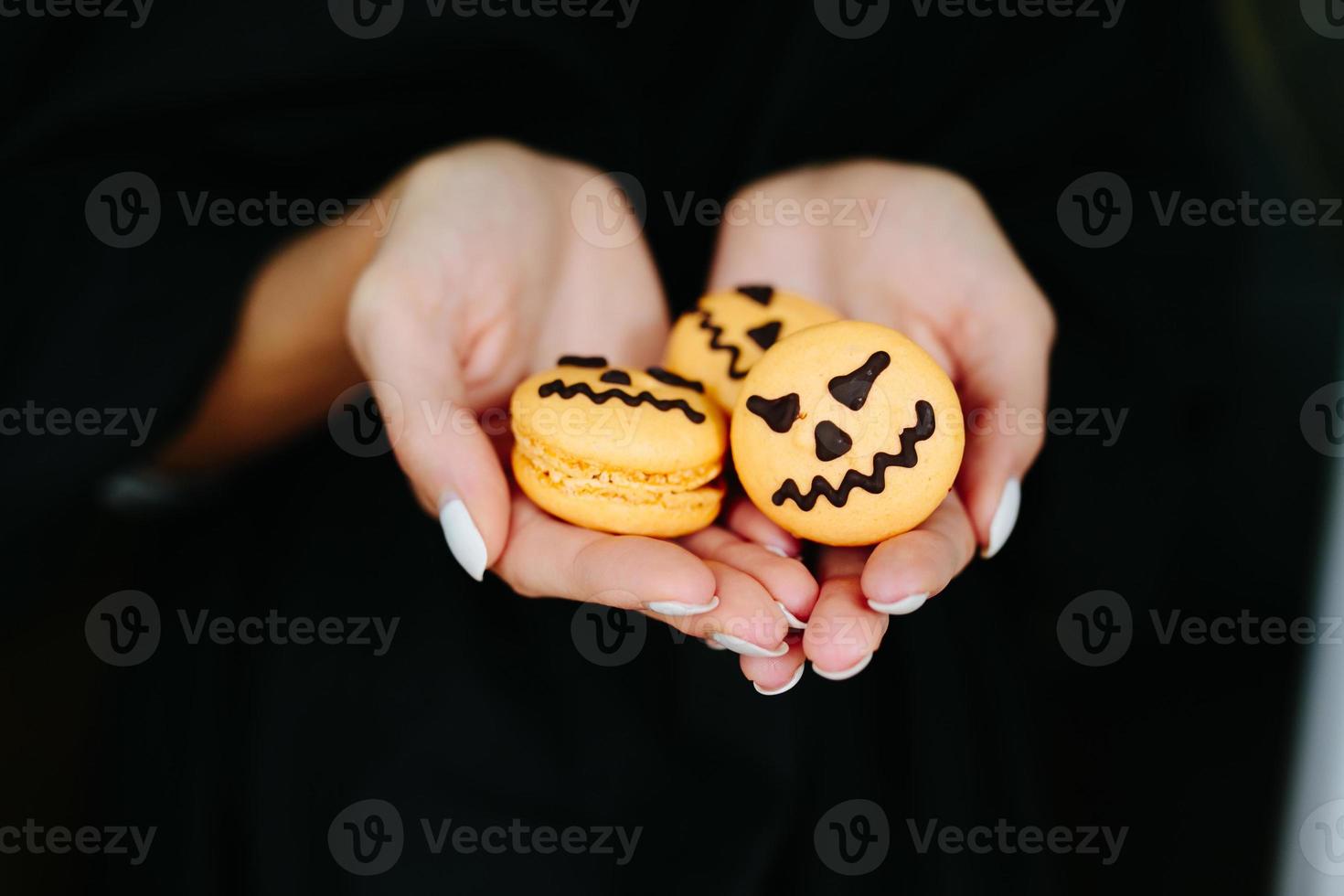 woman holding a biscuit for Halloween photo