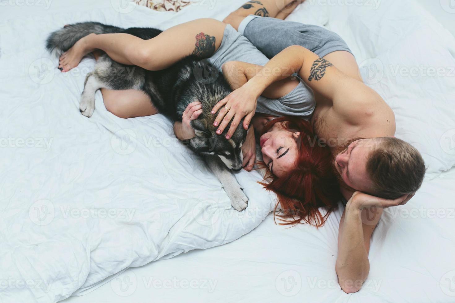 Young adult couple lying on bed photo