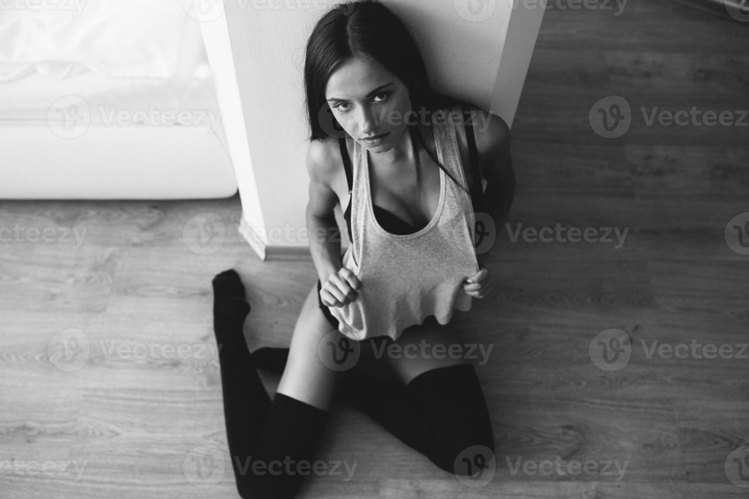 beautiful young girl posing sitting on the floor photo
