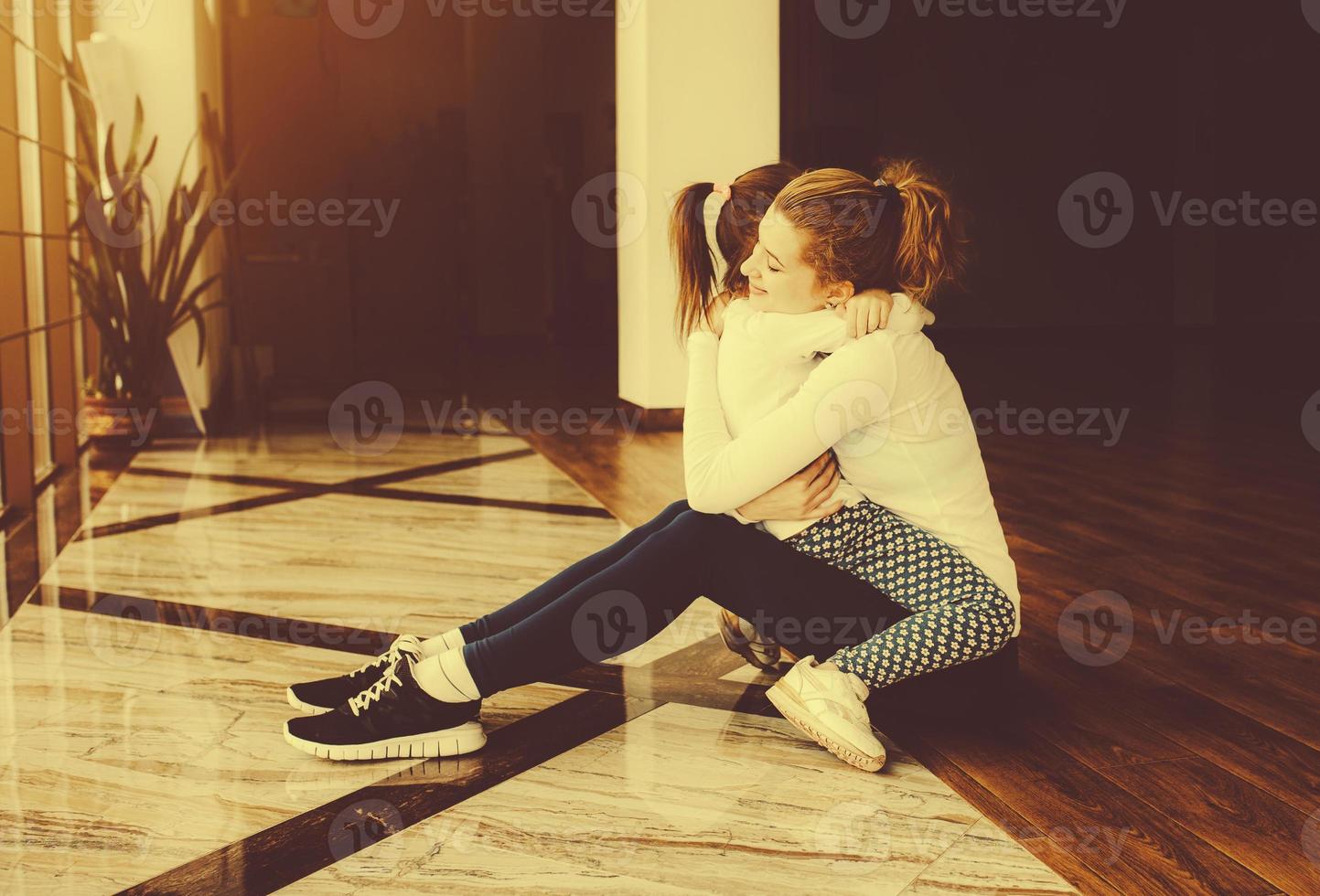 Mother and daughter hugging in the gym photo