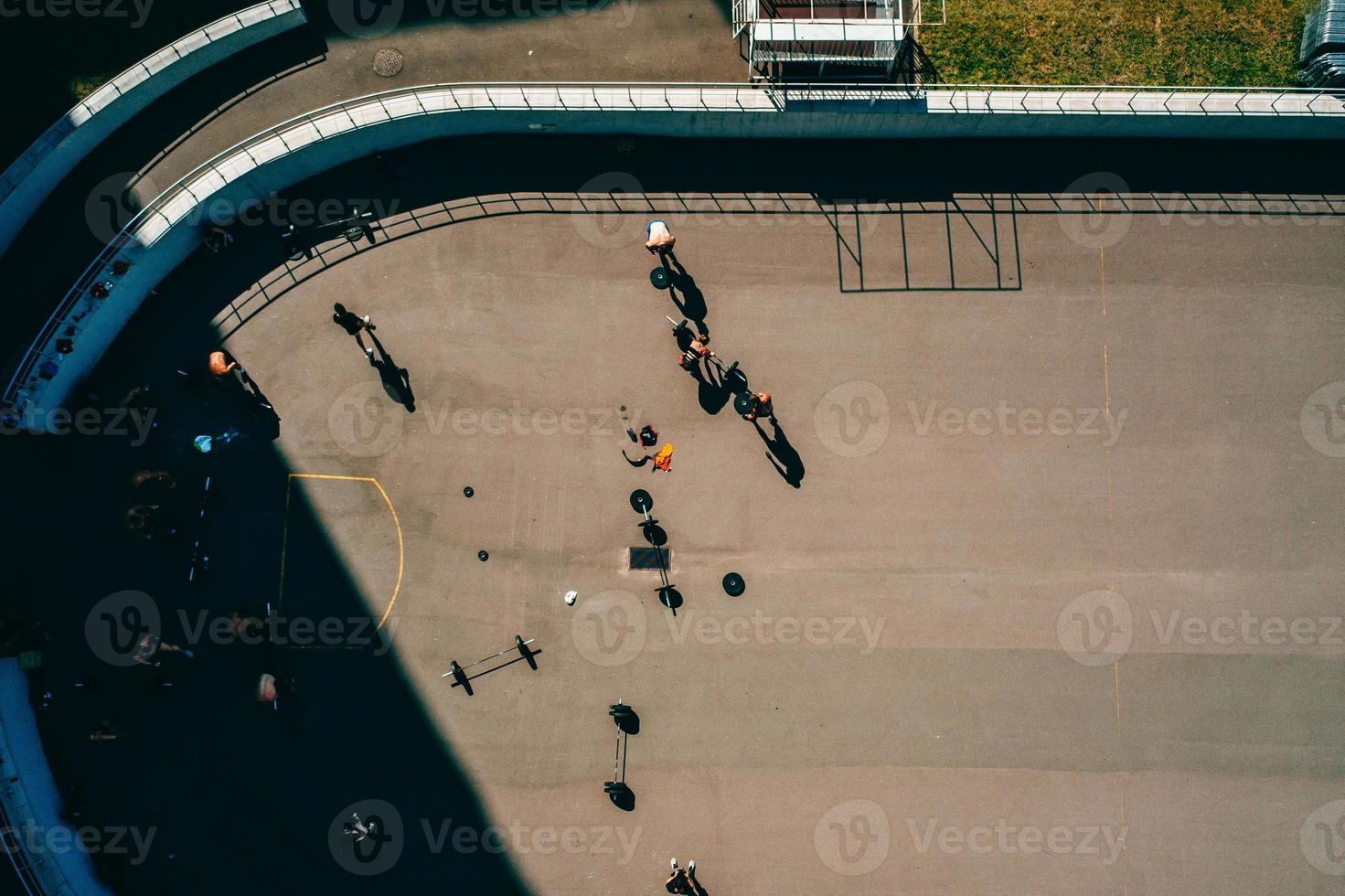 Aerial footage of a sports ground, people doing weightlifting photo