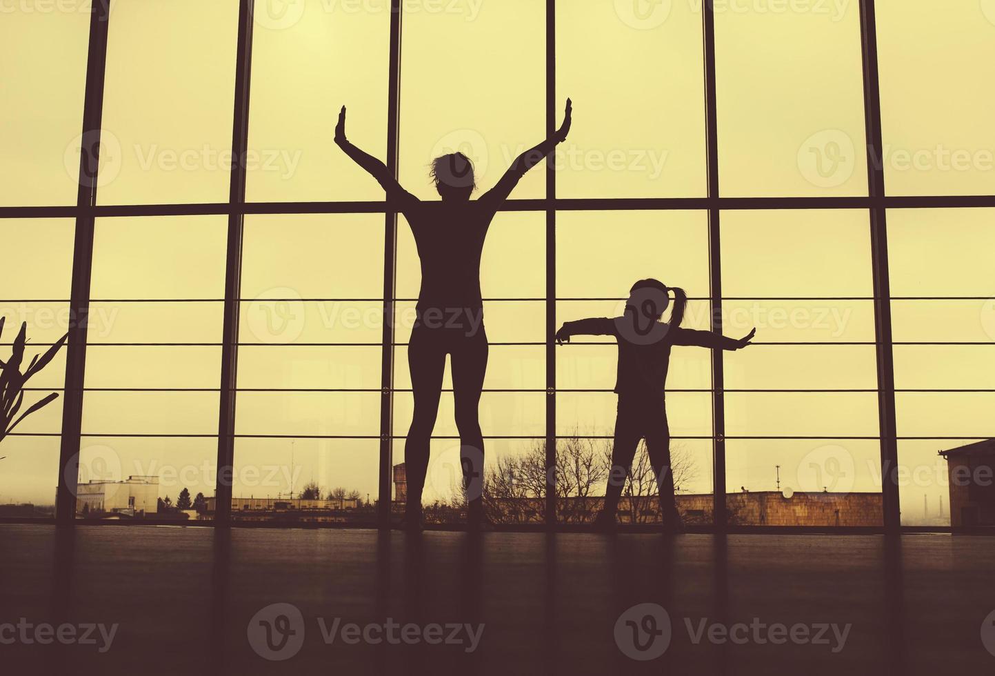 Silhouette of mother and daughter in the gym photo