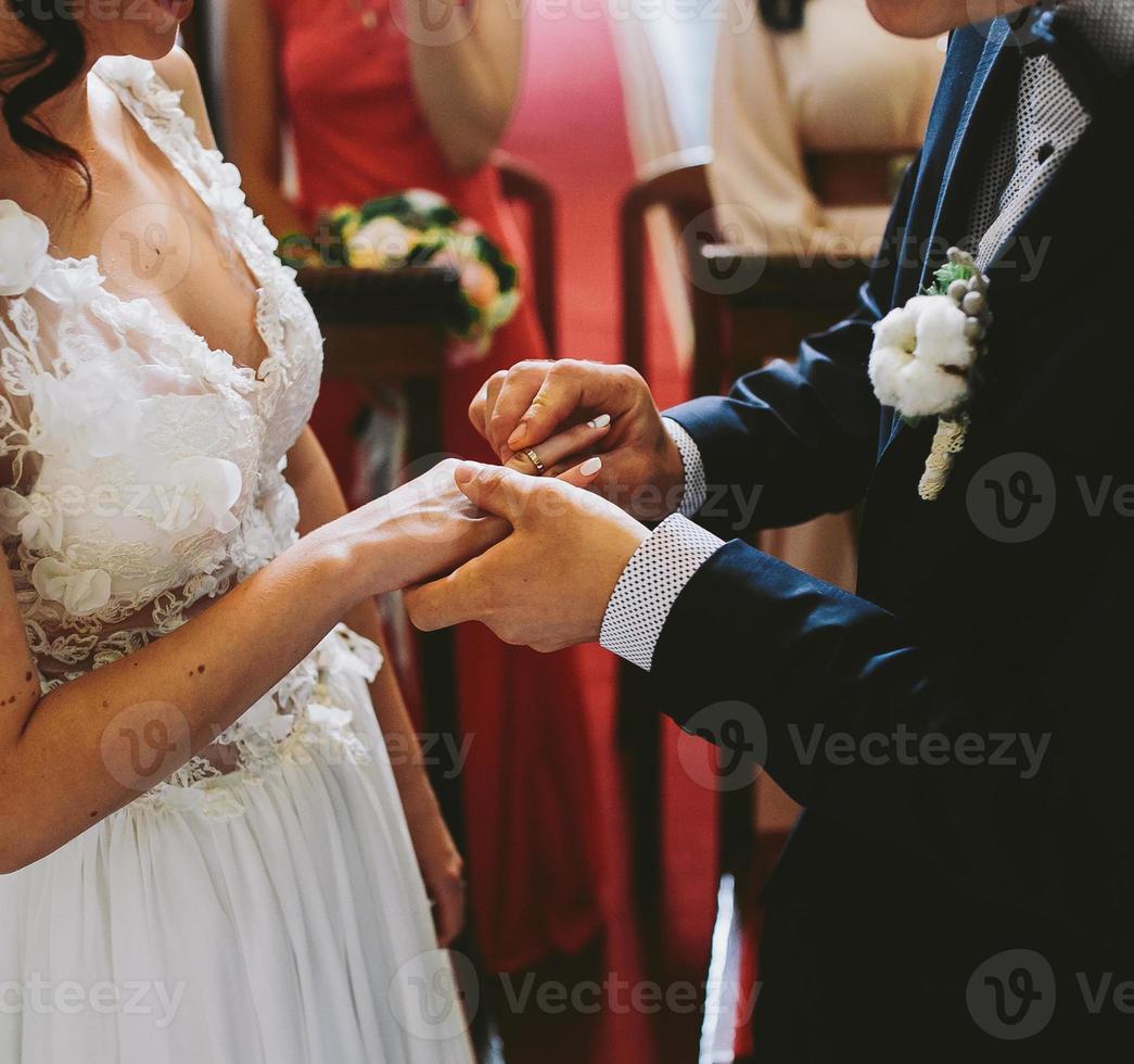 Putting the wedding ring on photo