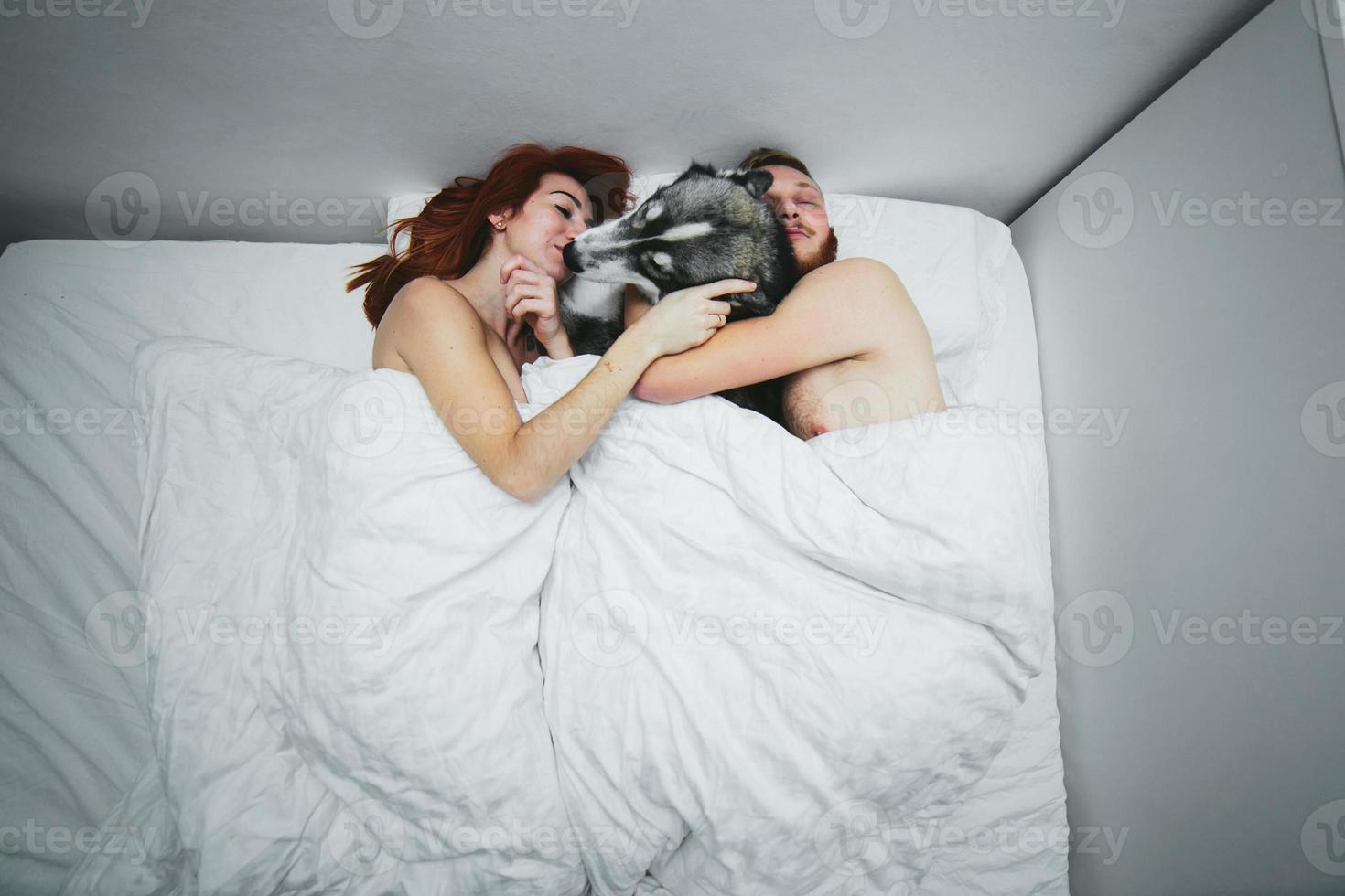 Young adult couple lying on bed photo