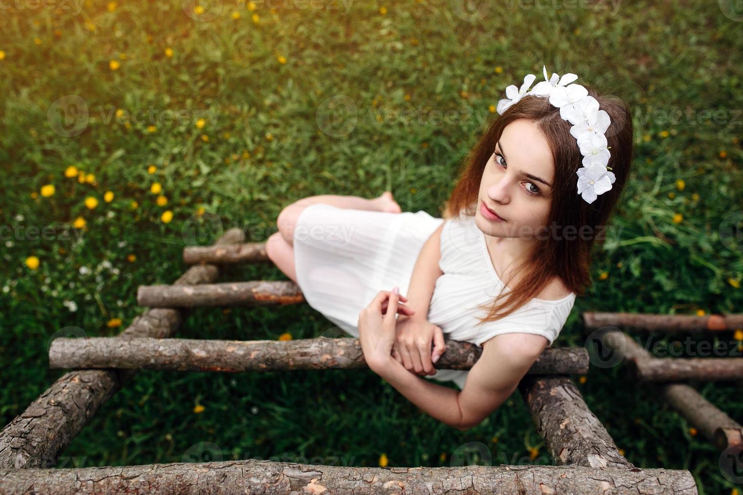 Lovely girl near a wooden house photo