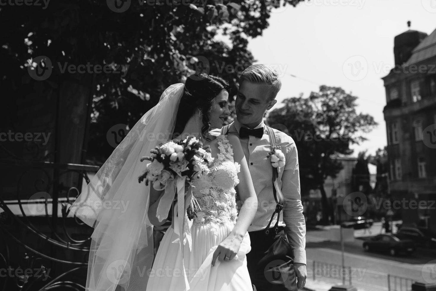 bride and groom posing on the streets photo