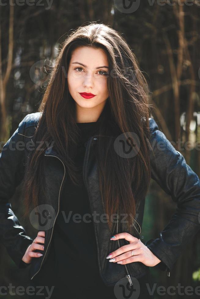 Glamorous young woman in black leather jacket photo