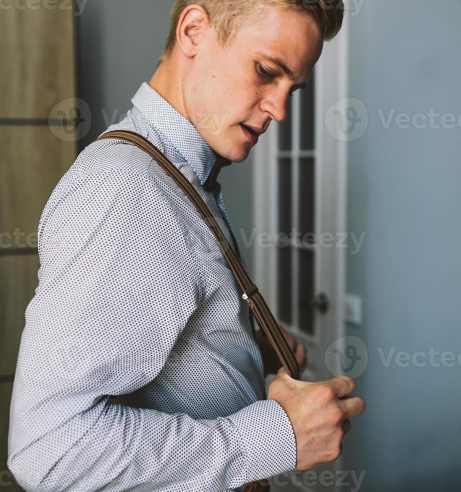 groom in the morning getting ready photo