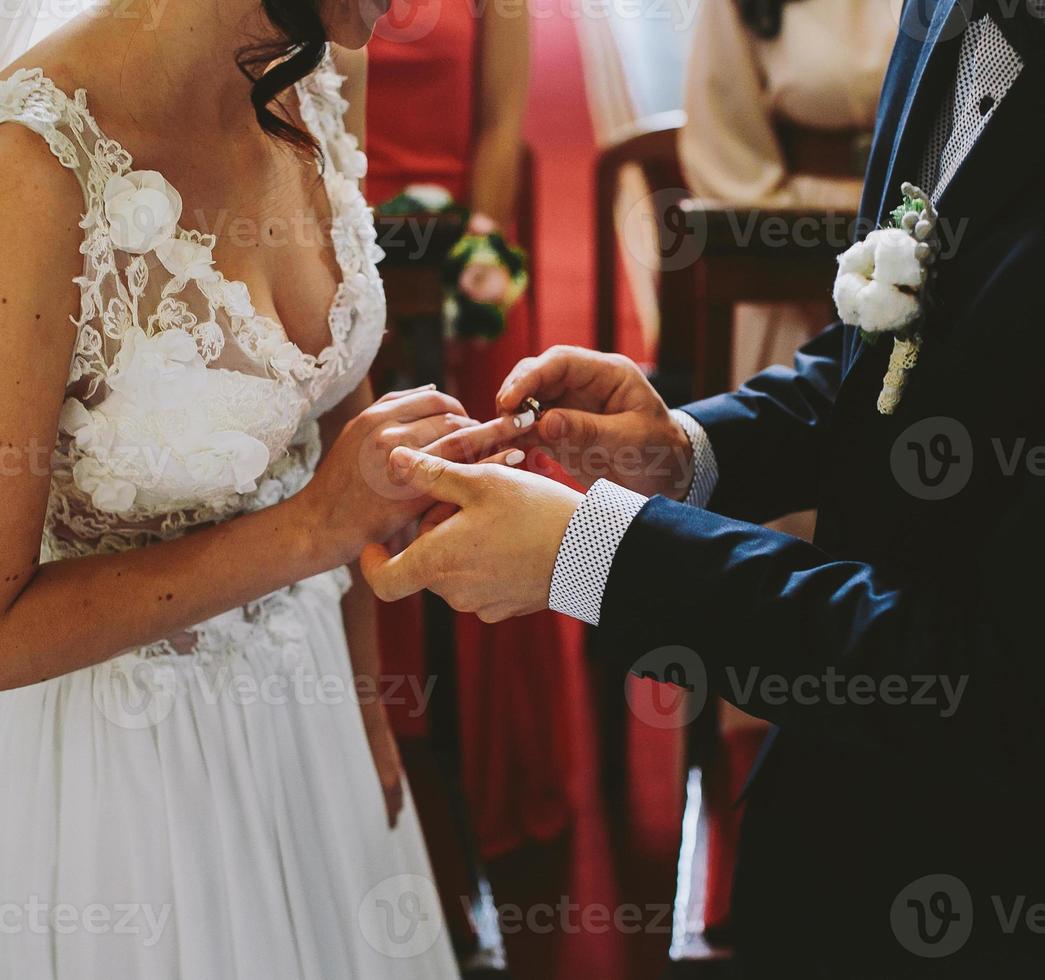 Putting the wedding ring on photo