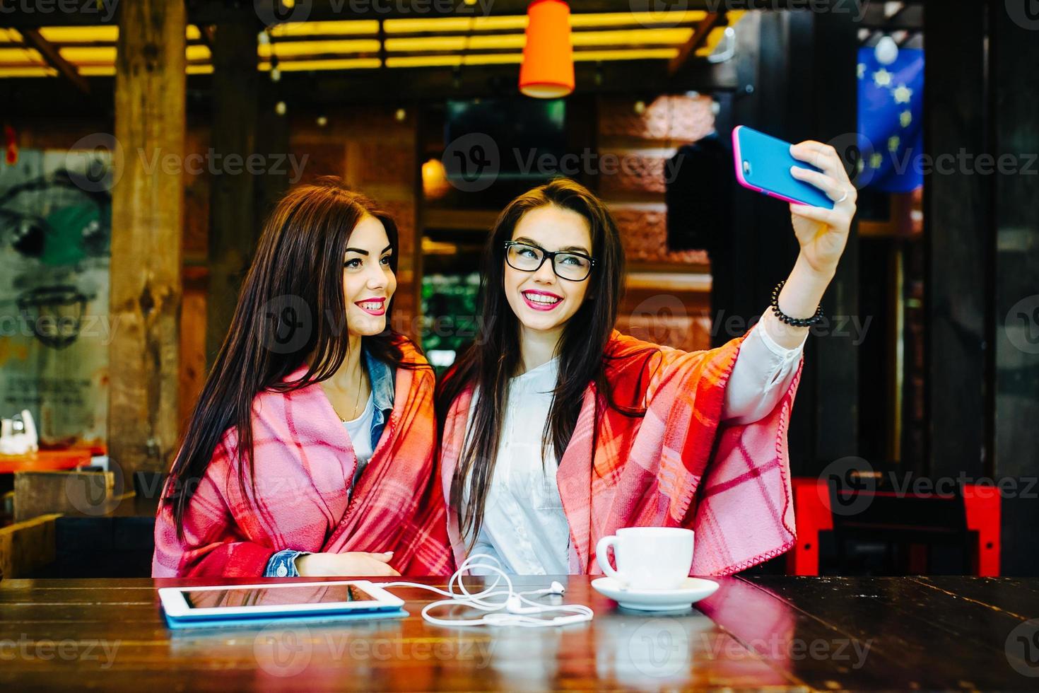 two close friends make selfie in the cafe photo