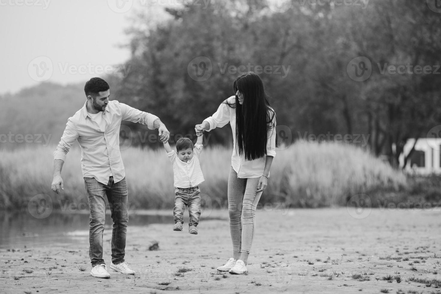 Young family walking at the beach photo