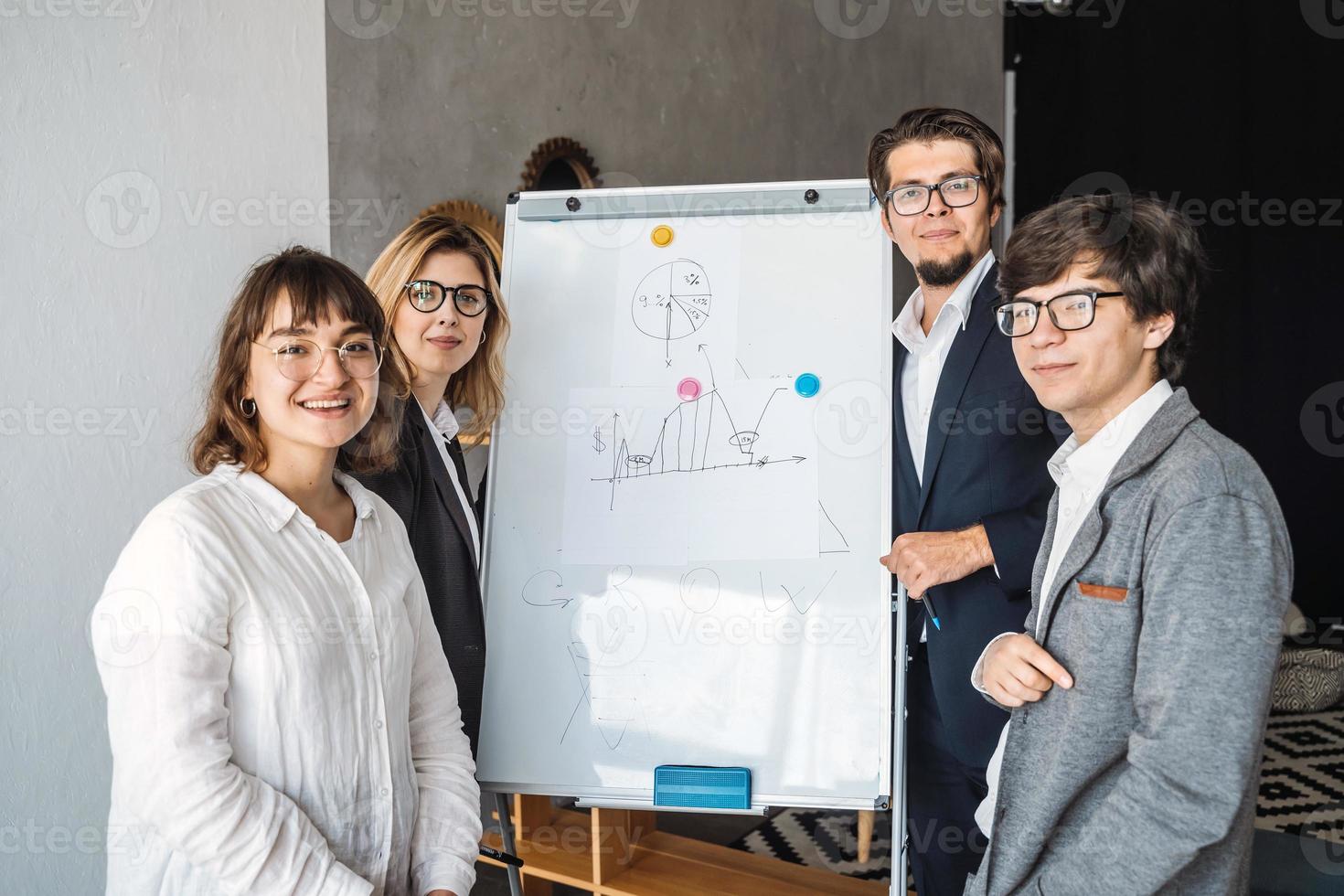 Businesspeople with whiteboard discussing strategy in a meeting photo