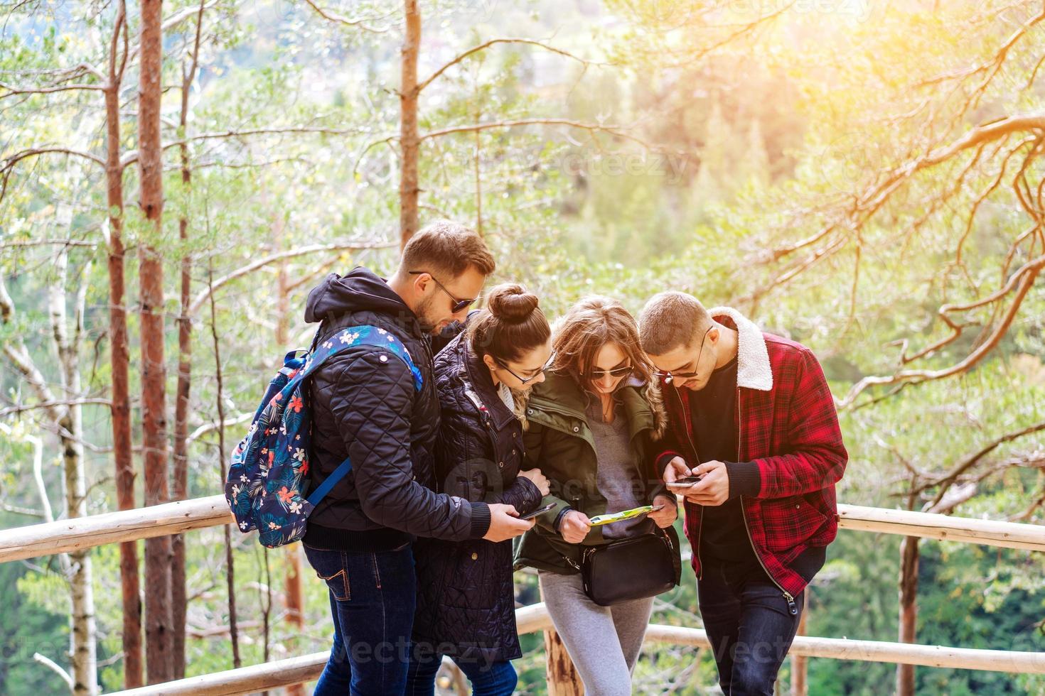 Four tourists trying to find the way photo