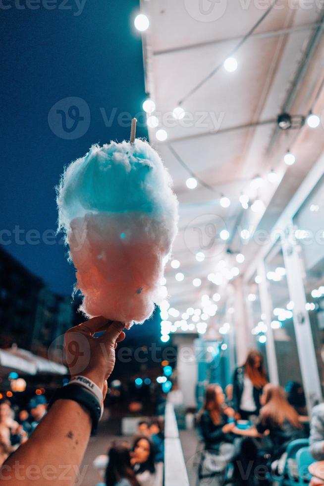 hand holding cotton candy photo