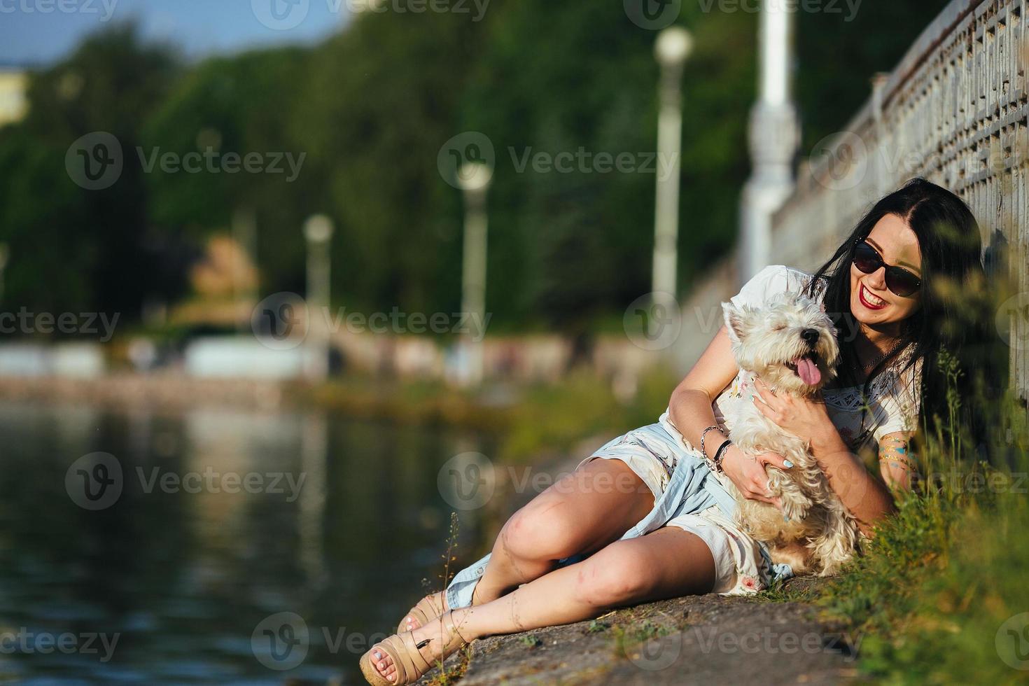 girl with a dog on the lake photo