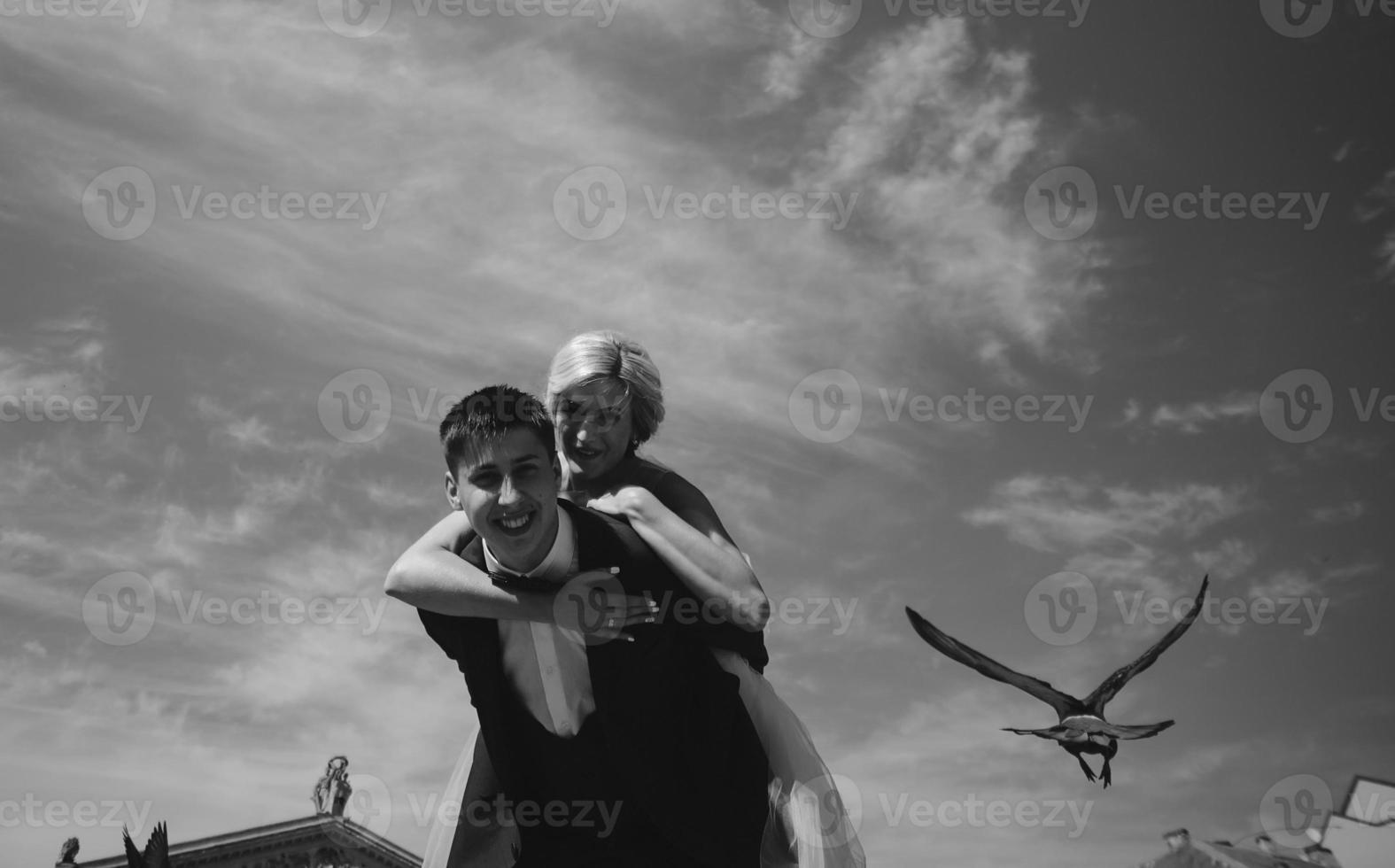 bride and groom  on the background of sky photo