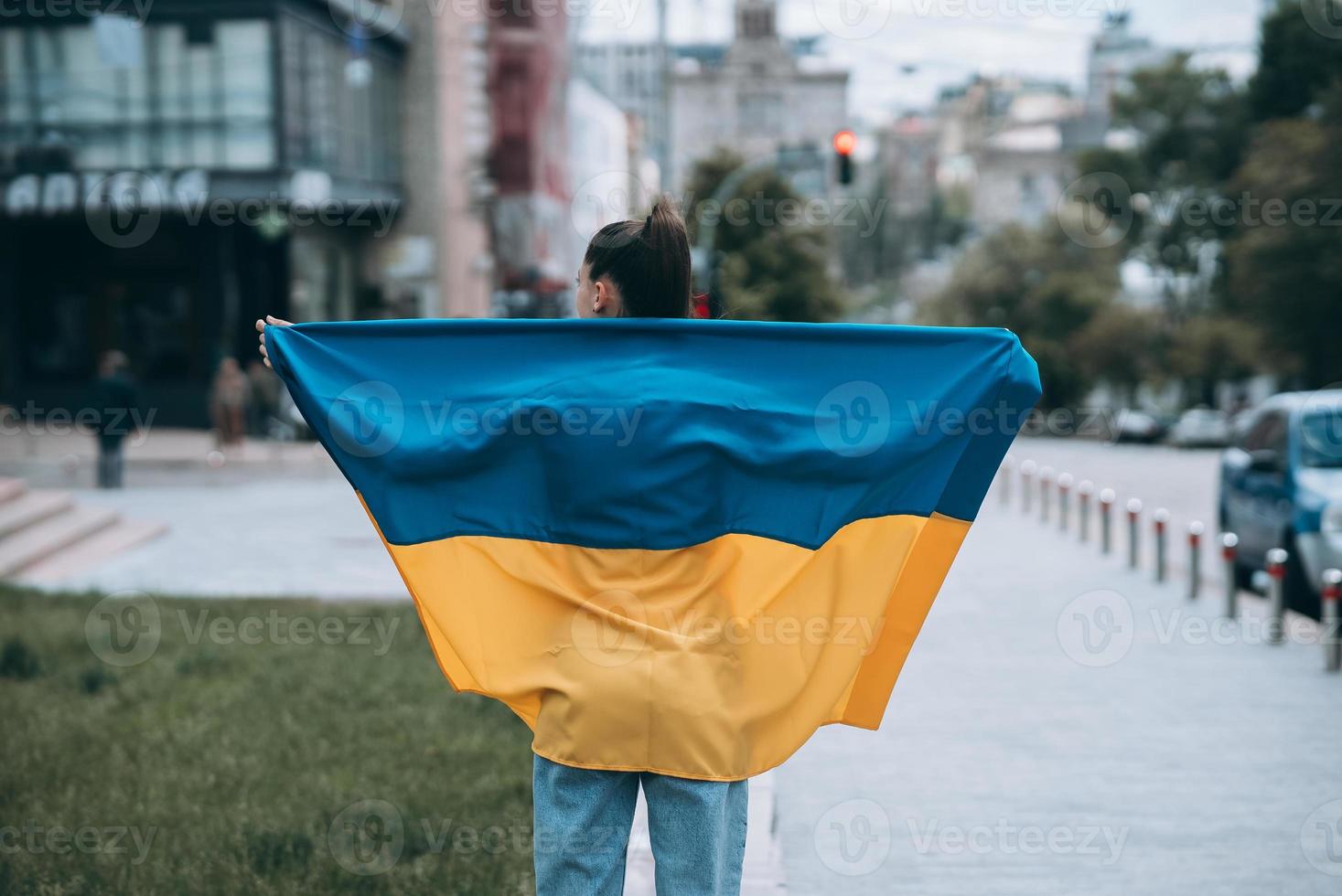 Young woman with national flag of Ukraine on the street photo