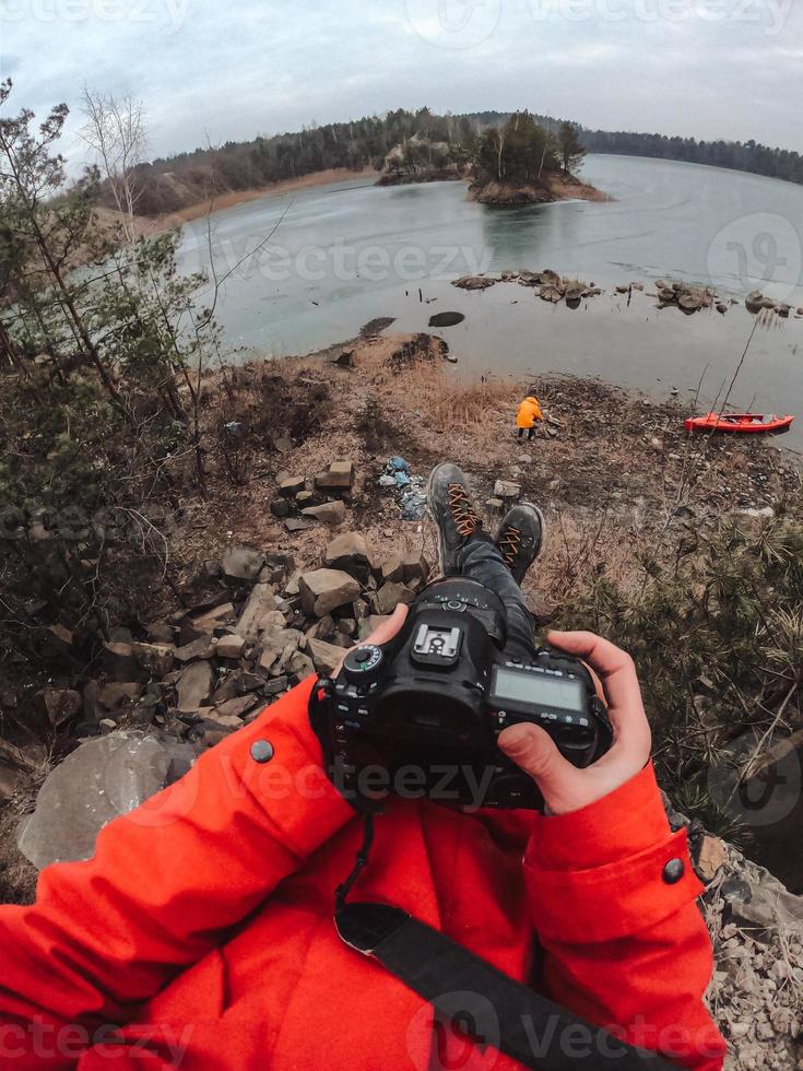 The guy is standing at the frozen lake photo