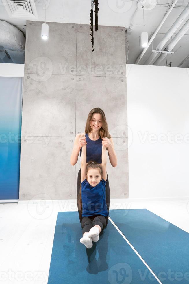 Mom and daughter do stretching before exercise photo