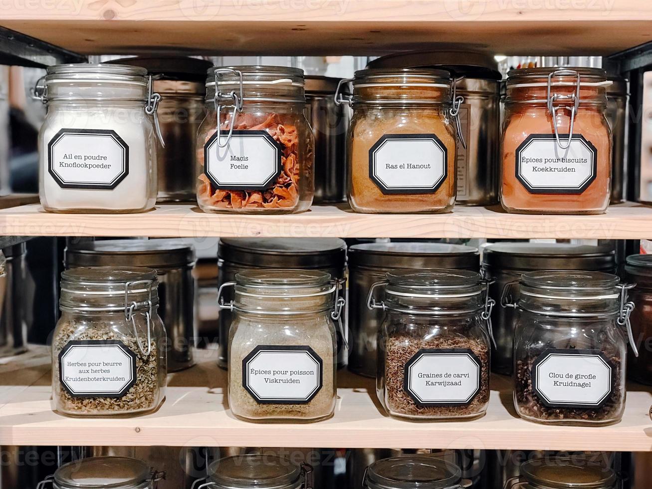 Cans with spices at the shelves photo