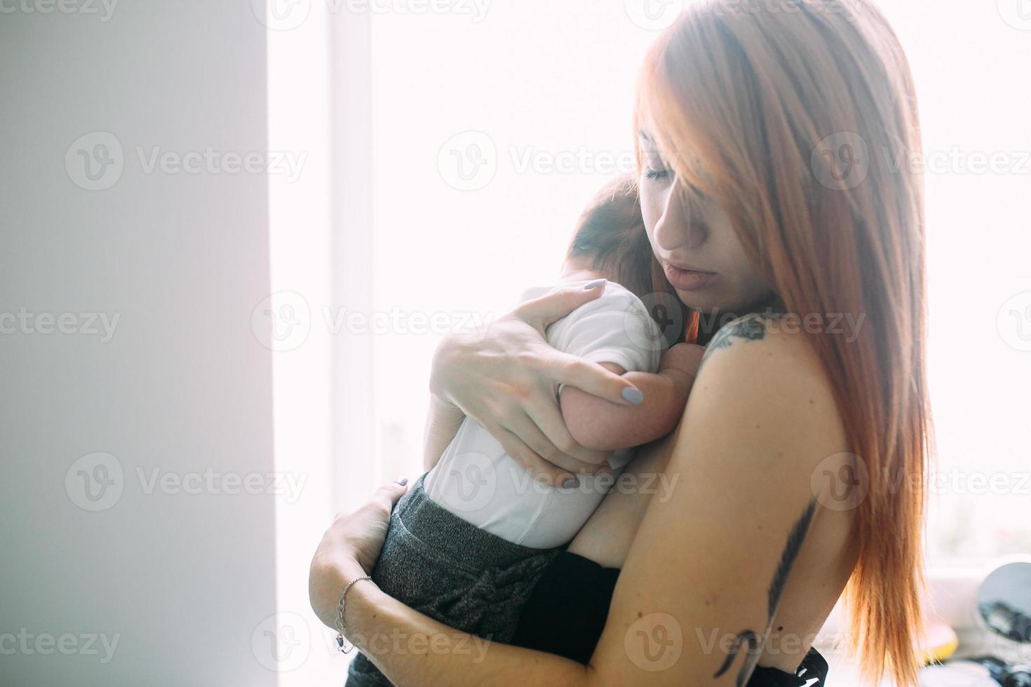 Young mother woman holding her child baby photo