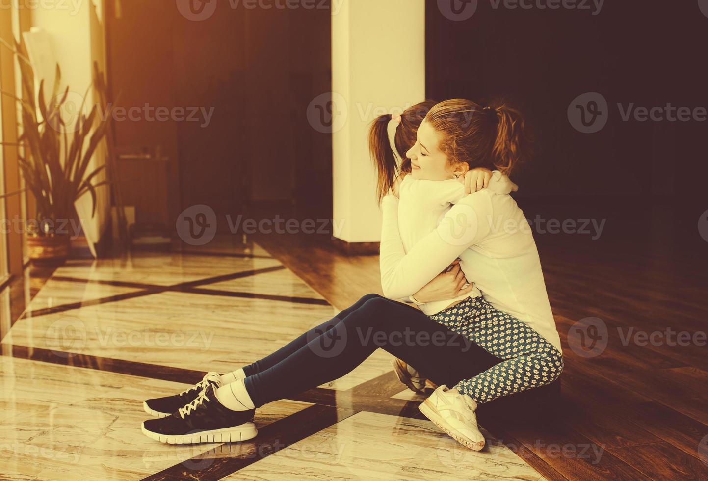 Mother and daughter hugging in the gym photo