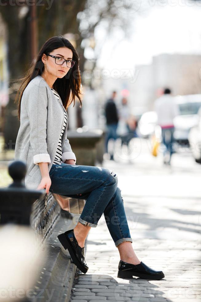 Beautiful model in a coat and glasses photo