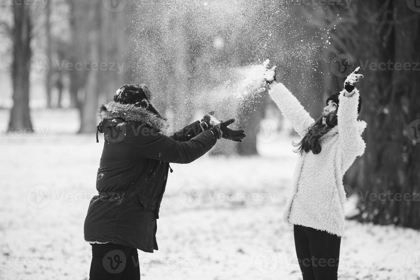 boy and girl playing with snow photo