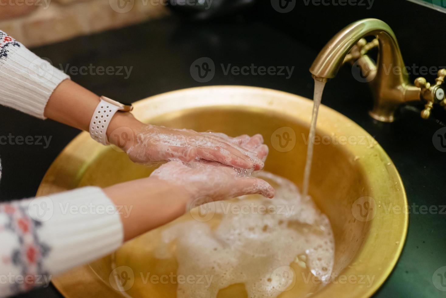 Close up photo of woman washes her hands with soap and water.