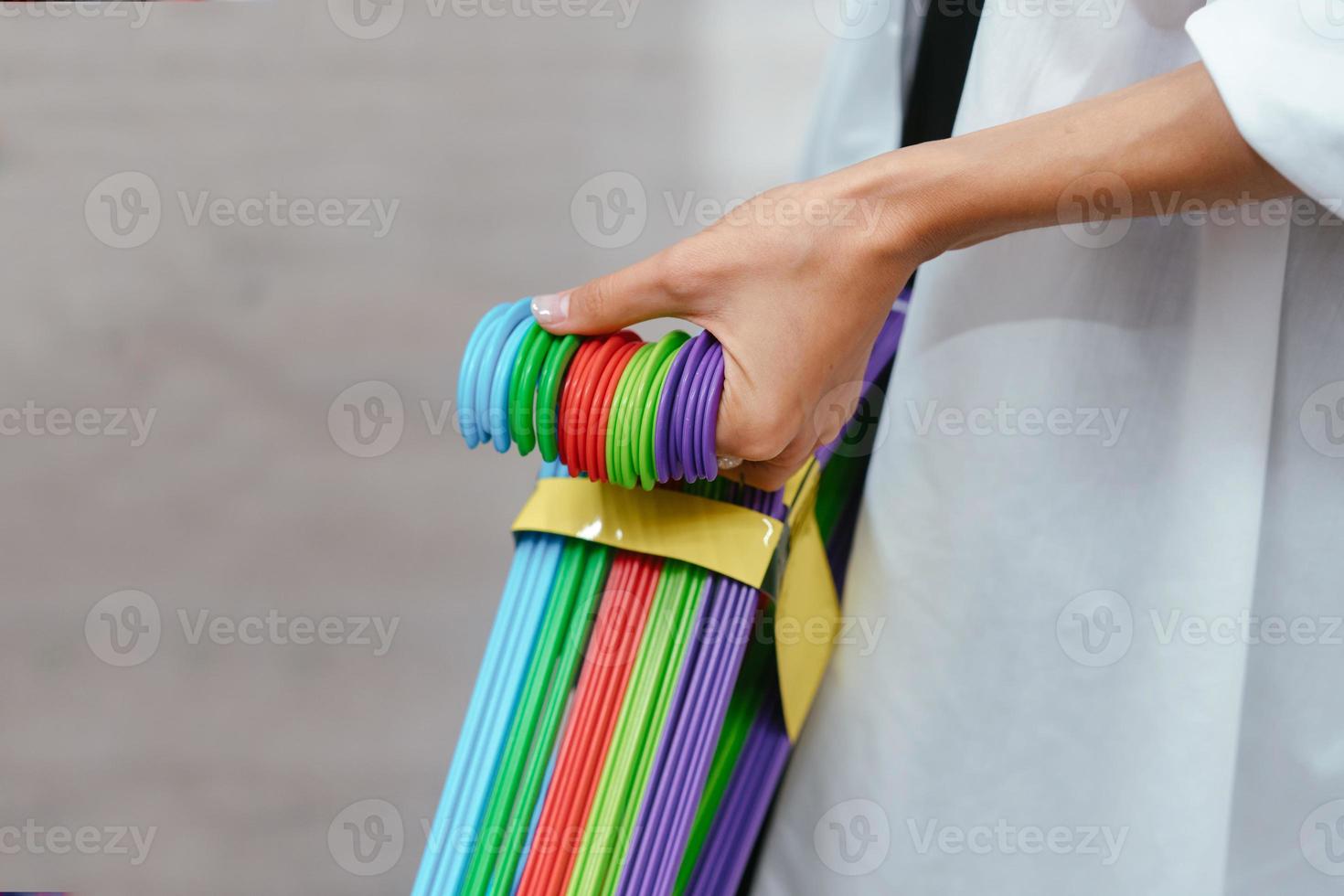 Female hand holding a set of hangers photo